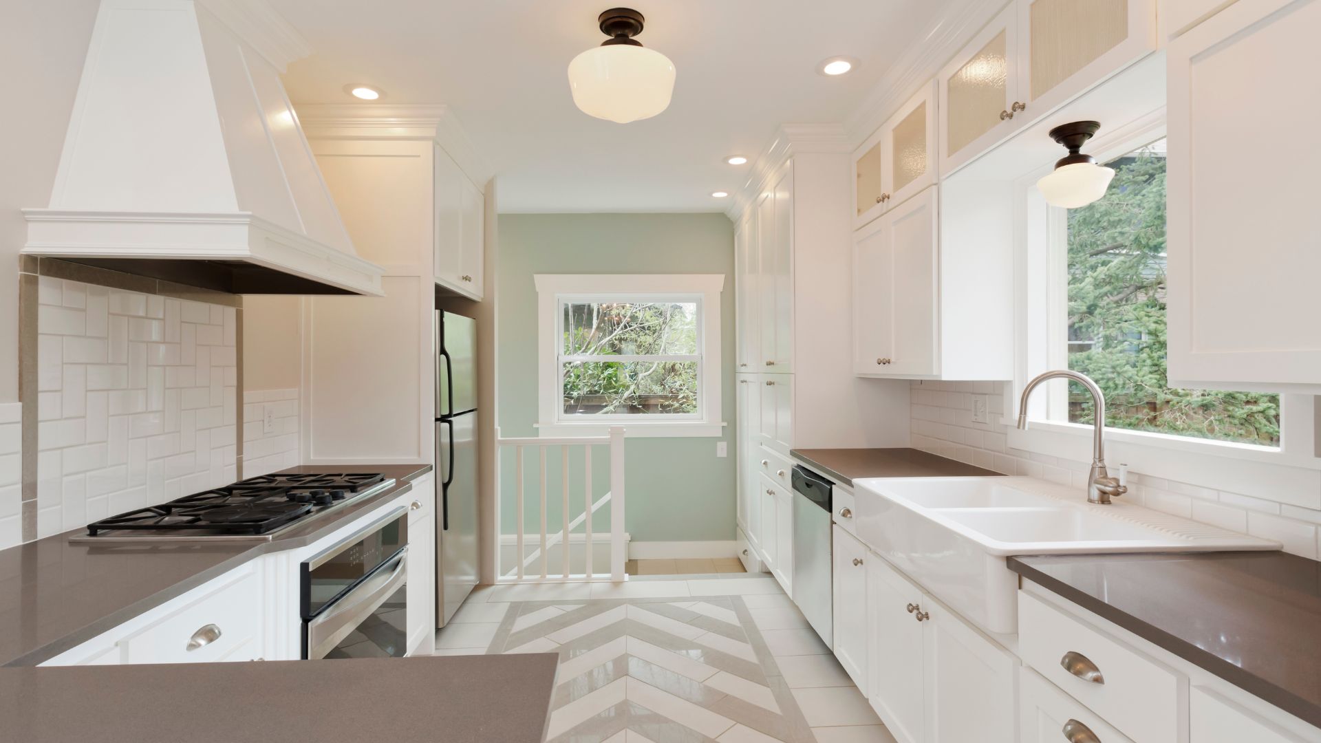 A kitchen with a stove top oven sitting next to a sink