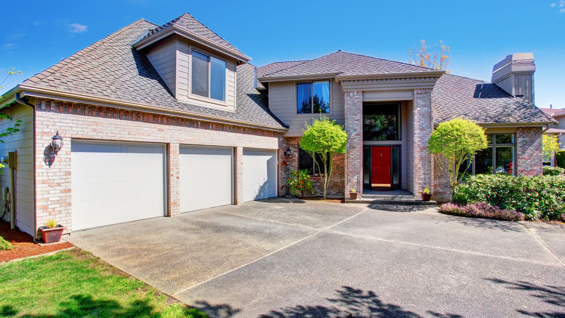 A large brick house with a red door