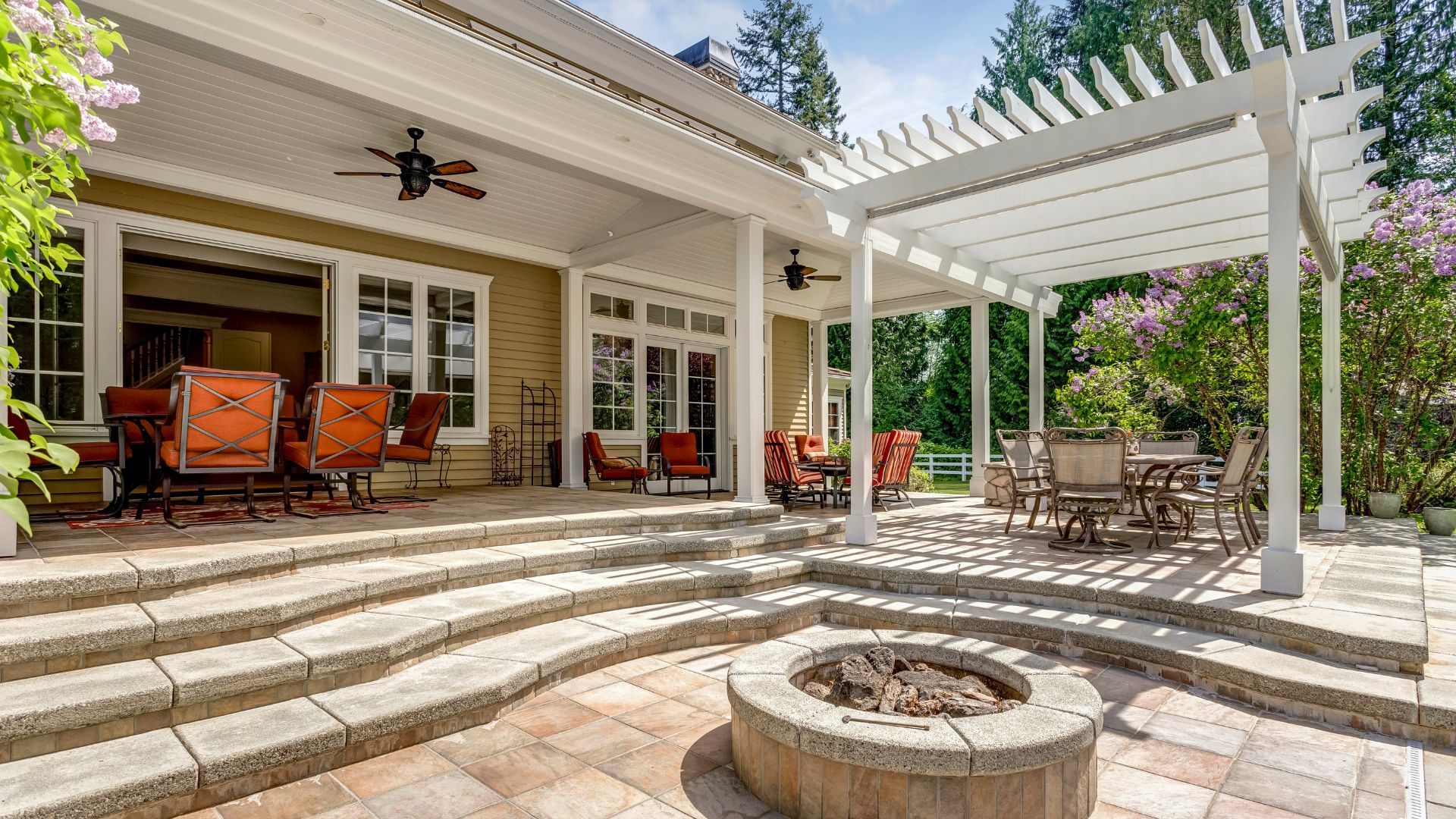 A patio with chairs and a fire pit