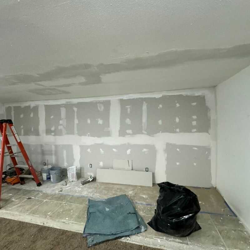 A room that is being remodeled with a ladder