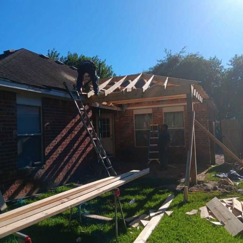 A man on a ladder working on a roof